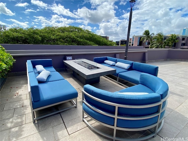 view of patio featuring an outdoor living space with a fire pit