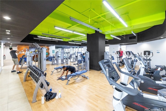 workout area with hardwood / wood-style floors