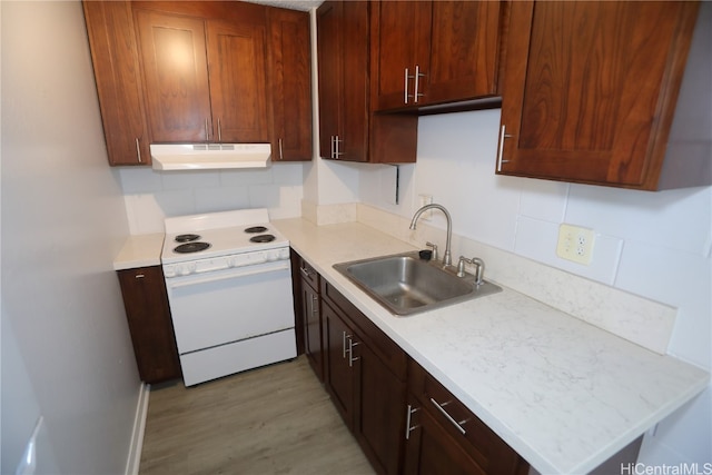 kitchen with white electric range, light wood-type flooring, sink, and backsplash