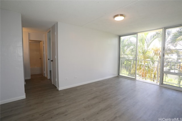 spare room with dark hardwood / wood-style floors