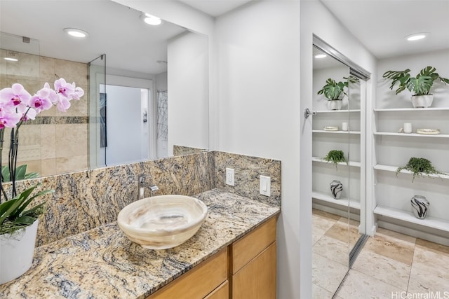 full bath featuring a stall shower, recessed lighting, decorative backsplash, and vanity