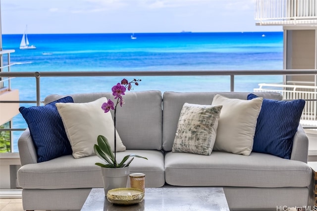 balcony with outdoor lounge area and a water view