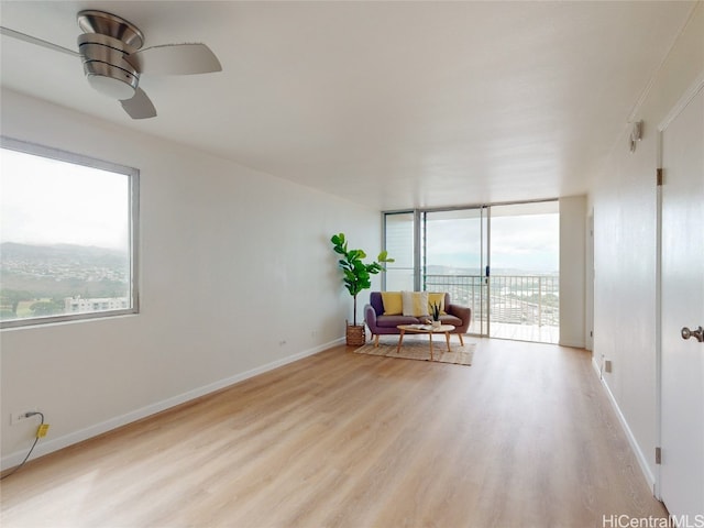 unfurnished room with light hardwood / wood-style floors and ceiling fan