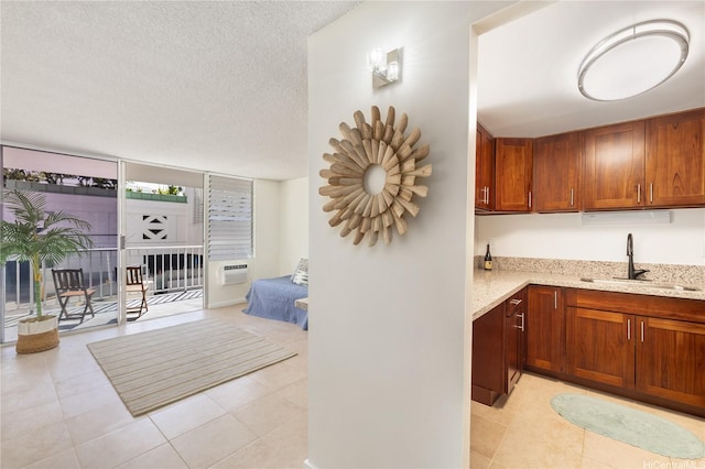 475 Atkinson Dr Unit 709, Honolulu, HI 96814 - kitchen with brown cabinetry, light tile patterned floors, light stone counters, and a sink