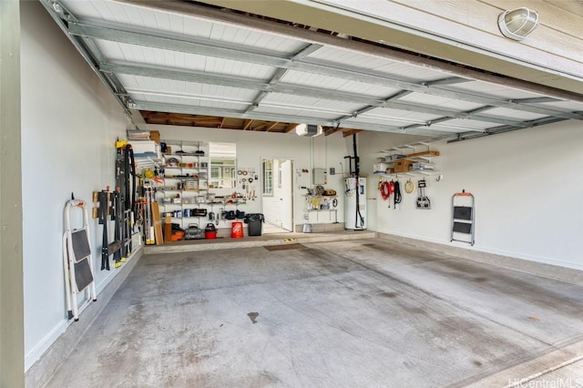 garage featuring water heater, a garage door opener, and a workshop area