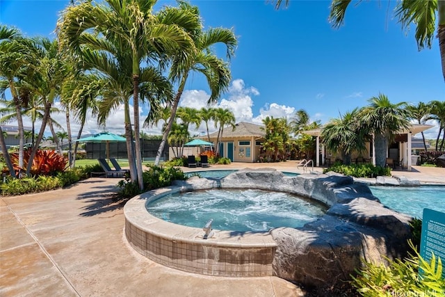 view of pool with an in ground hot tub and a patio area