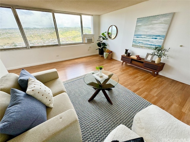 living room featuring cooling unit and hardwood / wood-style flooring