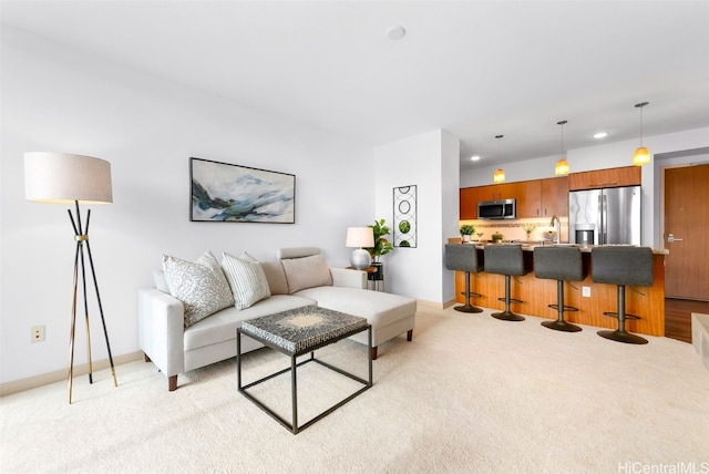 living room with sink and light carpet