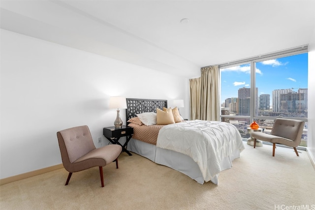 bedroom with light colored carpet and expansive windows