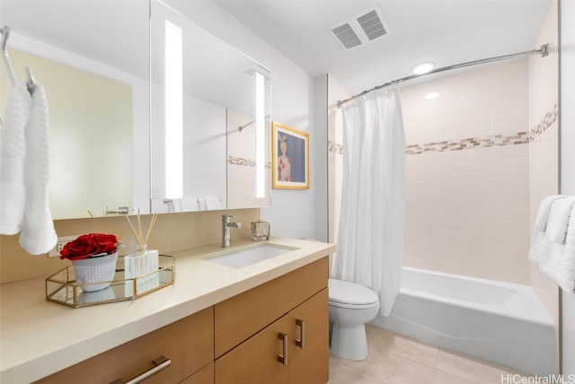 full bathroom featuring tile patterned floors, vanity, toilet, and shower / tub combo with curtain