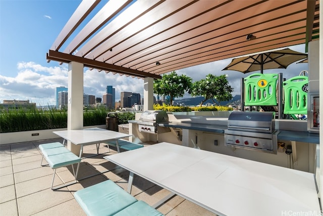 view of patio / terrace featuring an outdoor kitchen, a grill, and a pergola