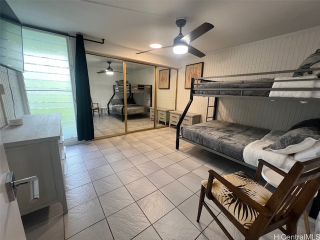 bedroom with ceiling fan and a closet