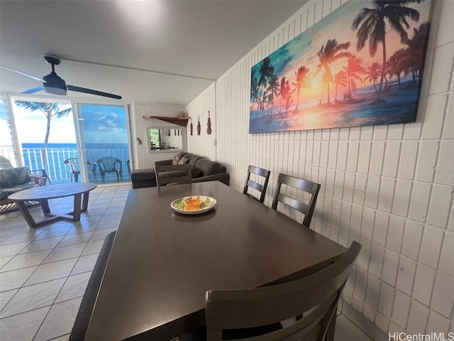 dining area featuring tile walls, ceiling fan, and light tile patterned floors