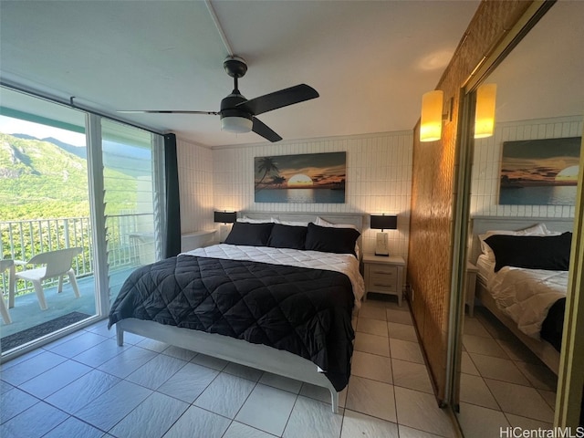 bedroom with access to outside and ceiling fan