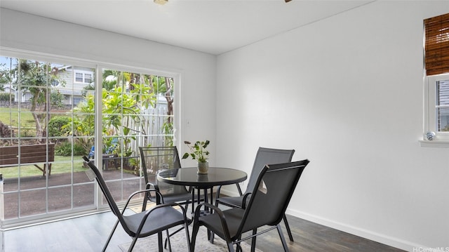 dining space featuring baseboards and wood finished floors