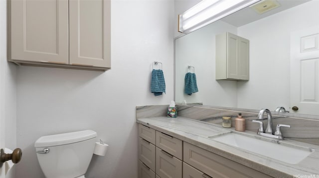 bathroom with toilet and vanity