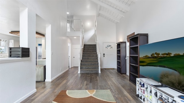 entryway featuring beamed ceiling, wooden ceiling, high vaulted ceiling, and dark wood-type flooring