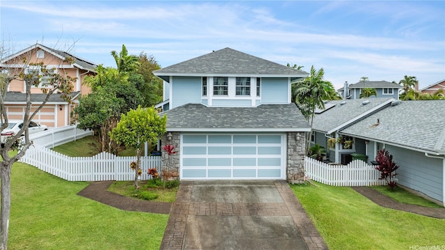 view of front of home featuring a shingled roof, a front lawn, stone siding, and concrete driveway