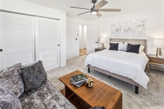 bedroom featuring ceiling fan, a closet, and light colored carpet