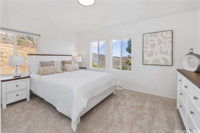 carpeted bedroom featuring multiple windows