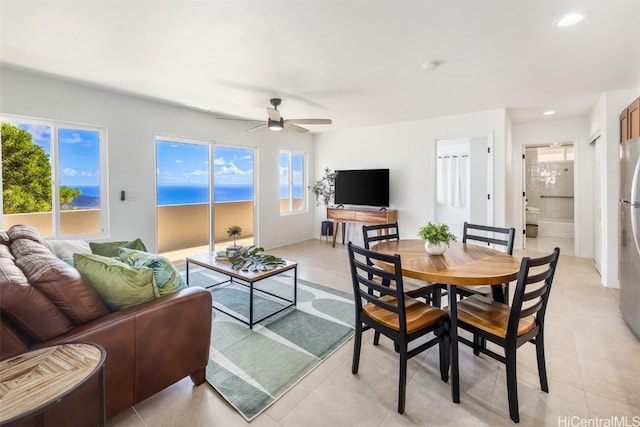 tiled dining space featuring a wealth of natural light and ceiling fan