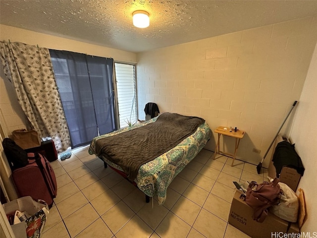 tiled bedroom with a textured ceiling