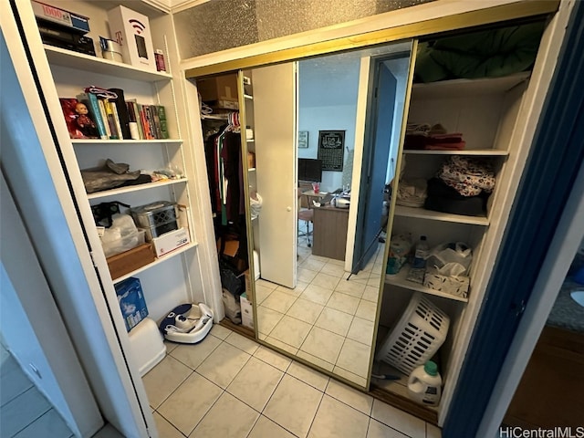 walk in closet with tile patterned floors