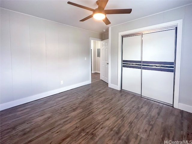 unfurnished bedroom with a closet, ceiling fan, and dark hardwood / wood-style flooring