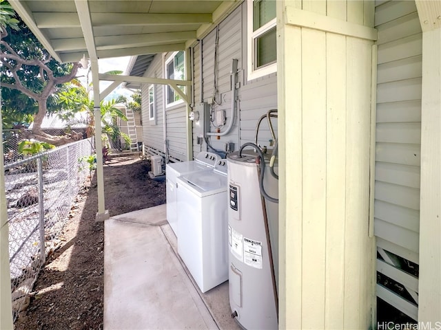 view of property exterior with water heater and washing machine and dryer