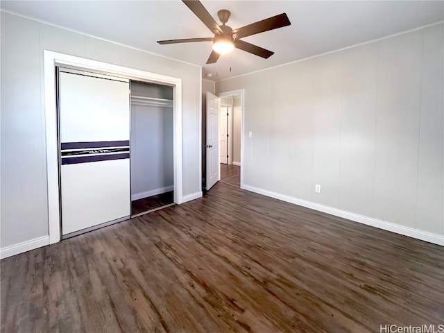 unfurnished bedroom with a closet, ceiling fan, and dark hardwood / wood-style floors