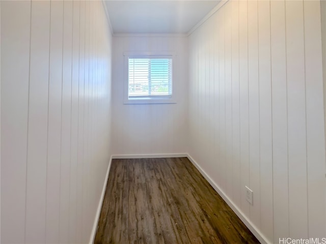 unfurnished room featuring ornamental molding, dark hardwood / wood-style flooring, and wooden walls