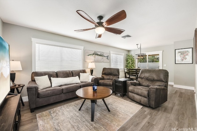 living room featuring hardwood / wood-style flooring and ceiling fan