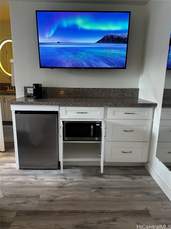 interior space with stainless steel appliances and hardwood / wood-style flooring