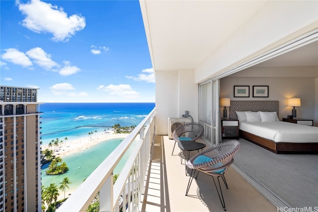 balcony featuring a view of the beach and a water view