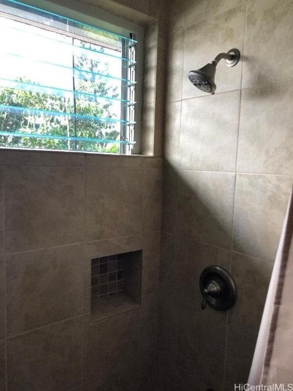 bathroom with a tile shower