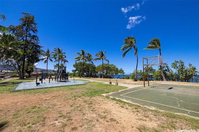 view of basketball court with a lawn