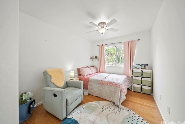 bedroom with ceiling fan and light hardwood / wood-style flooring