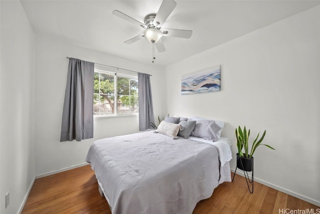 bedroom with ceiling fan and wood-type flooring