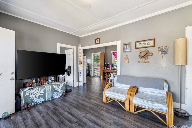 living room featuring crown molding and dark hardwood / wood-style floors