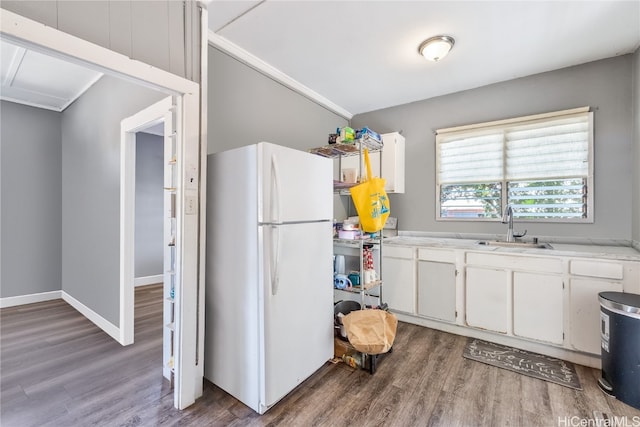 kitchen featuring white fridge, white cabinetry, dark hardwood / wood-style flooring, and sink