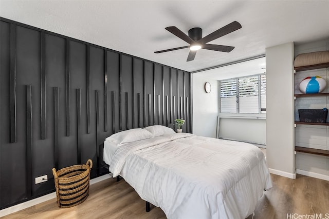 bedroom with hardwood / wood-style flooring and ceiling fan