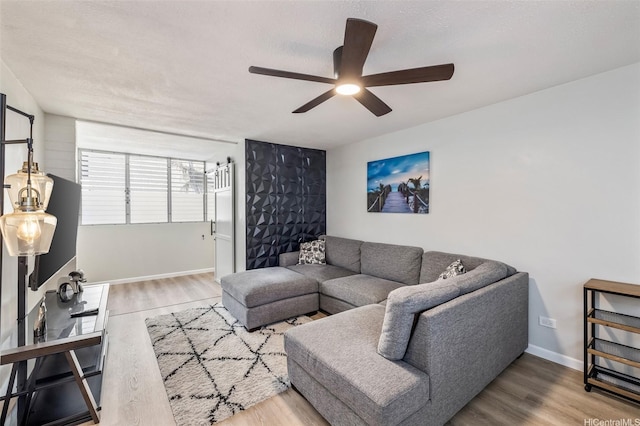 225 Liliuokalani Ave Unit 5C, Honolulu, HI 96815 - living room featuring a ceiling fan and wood finished floors