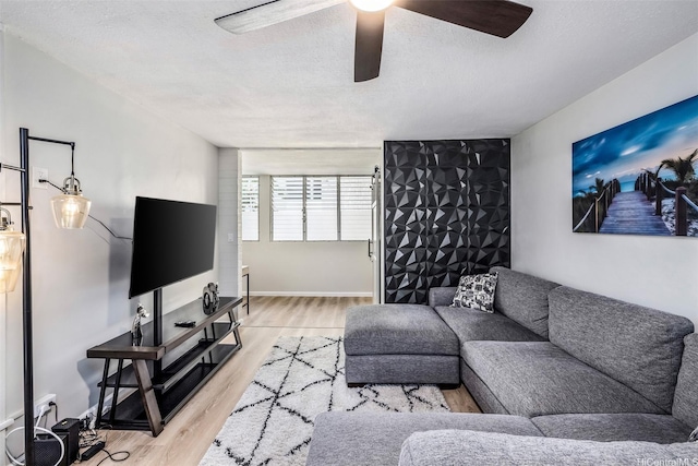 225 Liliuokalani Ave Unit 5C, Honolulu, HI 96815 - living room featuring a ceiling fan, wood finished floors, and a textured ceiling