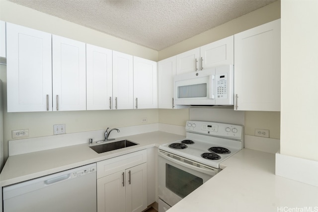 kitchen featuring sink, white cabinets, a textured ceiling, and white appliances