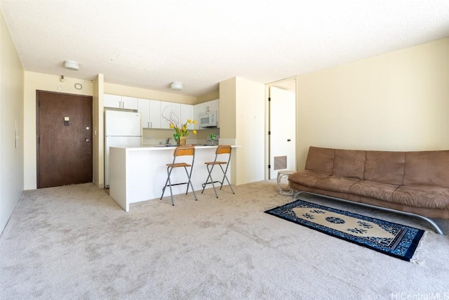 living area featuring light colored carpet and visible vents