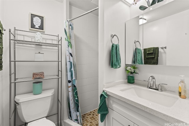 bathroom featuring vanity, toilet, and walk in shower