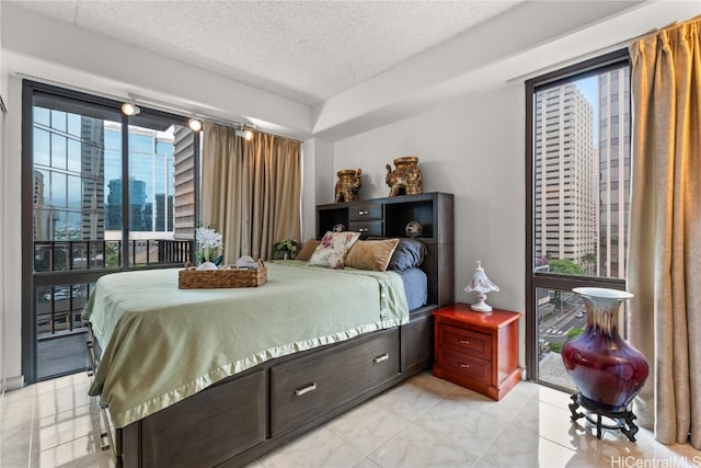 bedroom featuring access to exterior and a textured ceiling