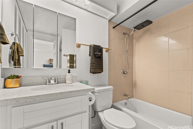 full bathroom featuring vanity, toilet, and tiled shower / bath combo