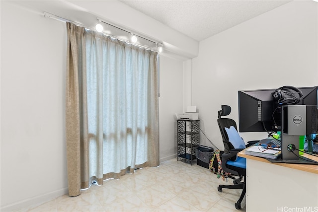 office with track lighting and a textured ceiling