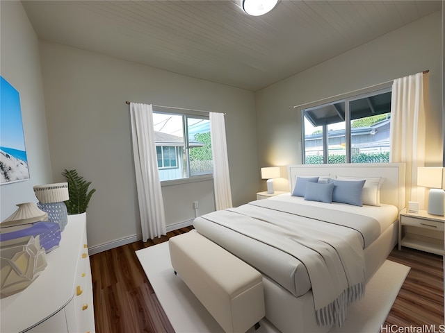 bedroom with multiple windows and dark hardwood / wood-style flooring